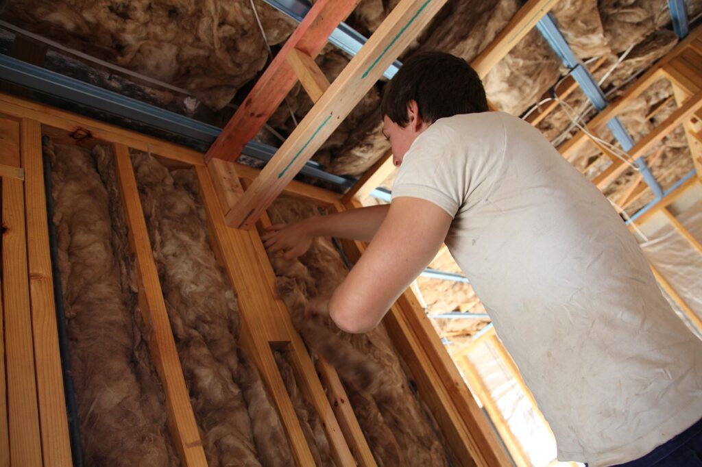 A person installing insulation.