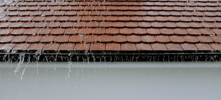 Clean roof gutter with heavy rain