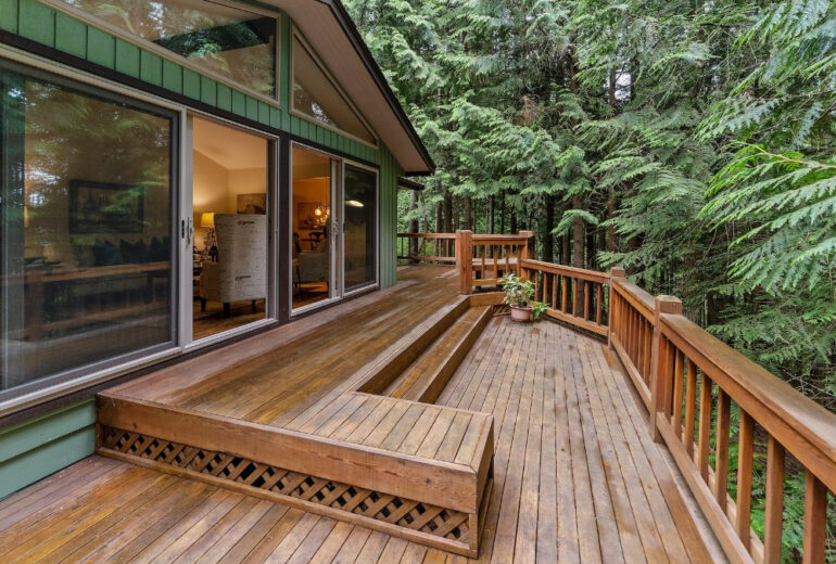 A beautiful deck in a forest home.