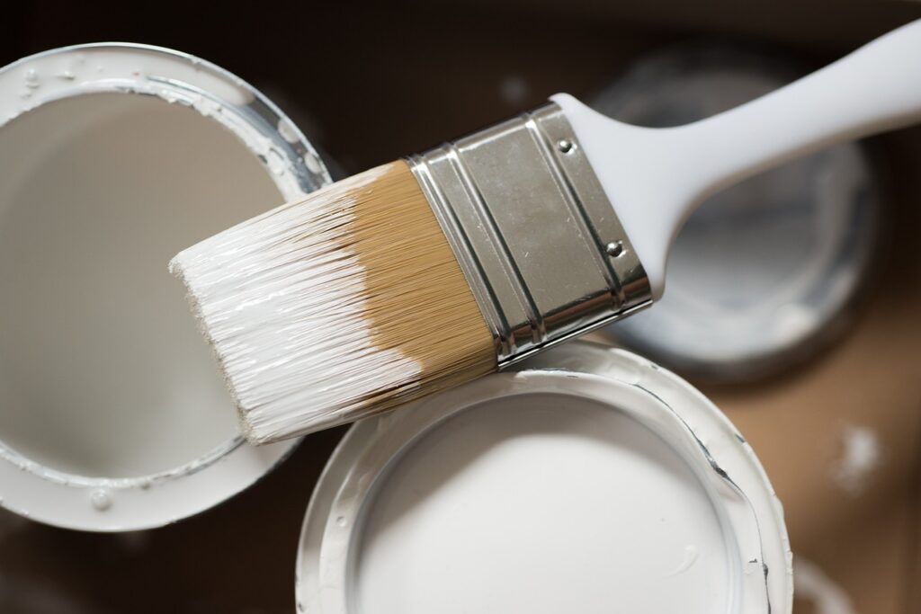 What is the longest lasting exterior paint for a house? - a picture with 3 open paint cans and a paint brush