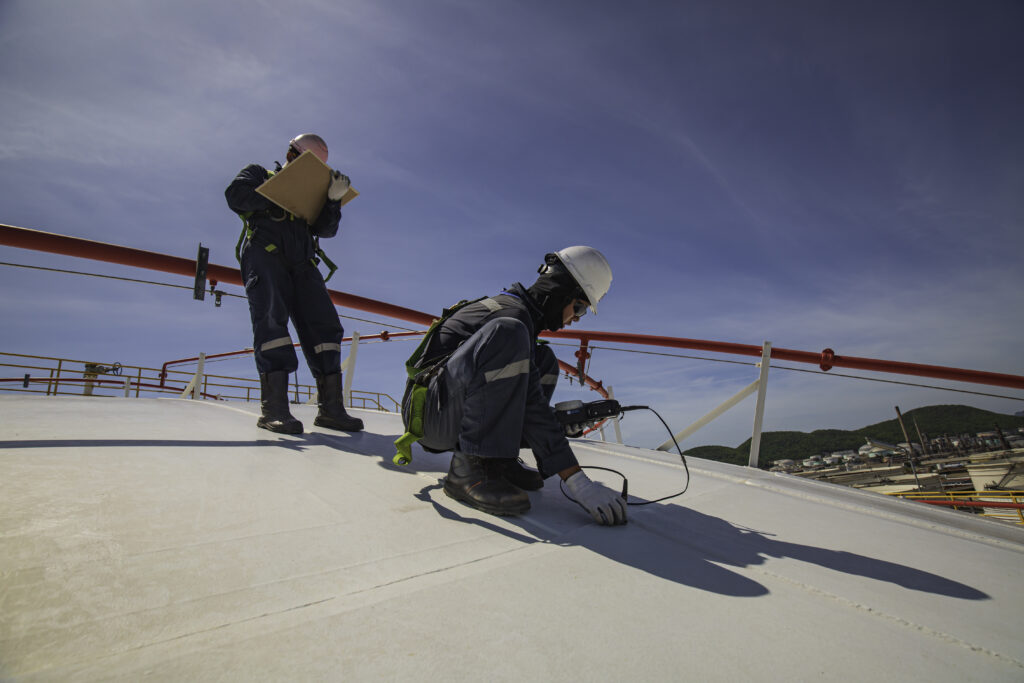 Commercial roof repair minneapolis, mn: two roofers testing a roof
